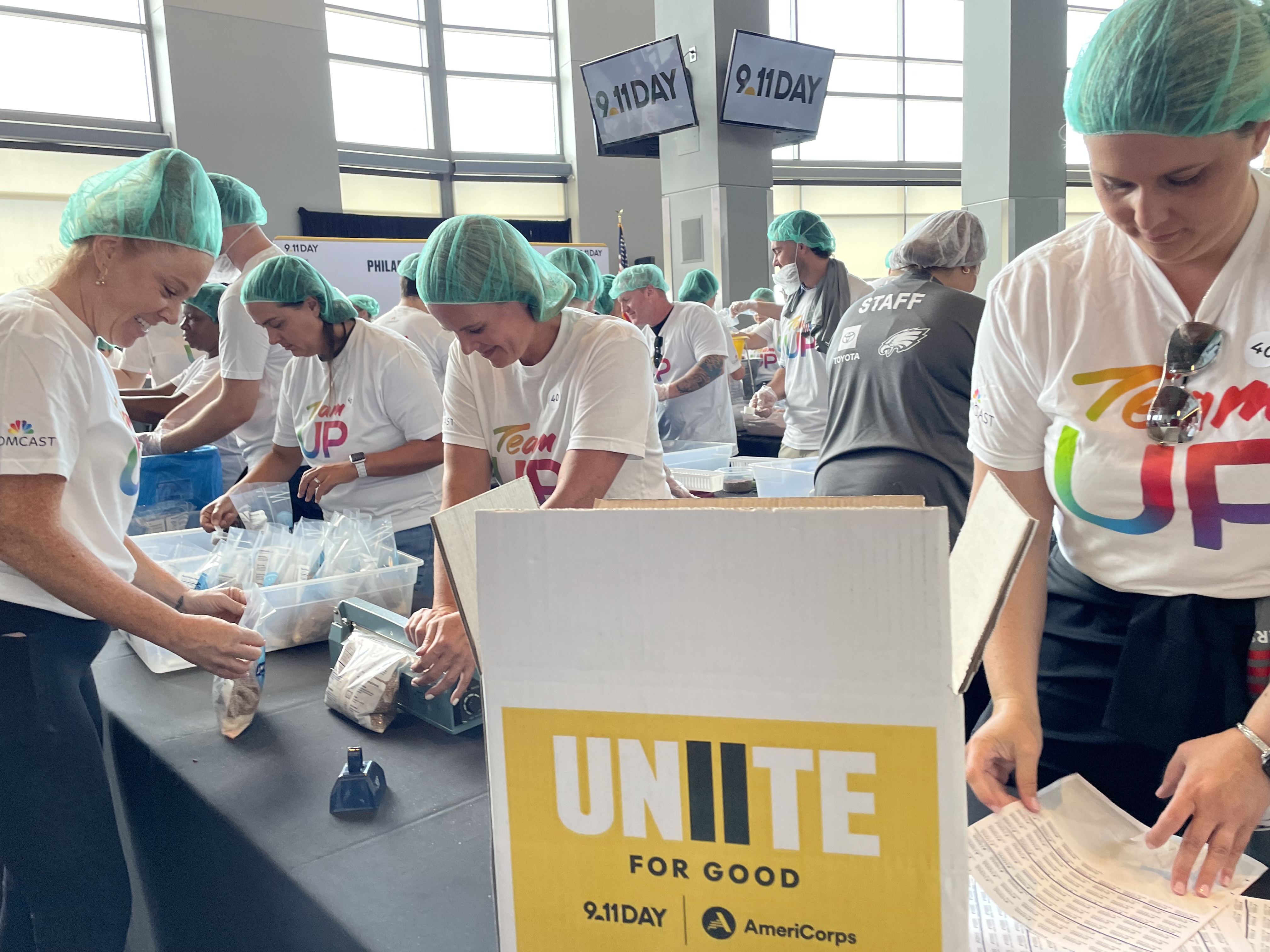 Comcast Team UP volunteers packing meals in Philadelphia