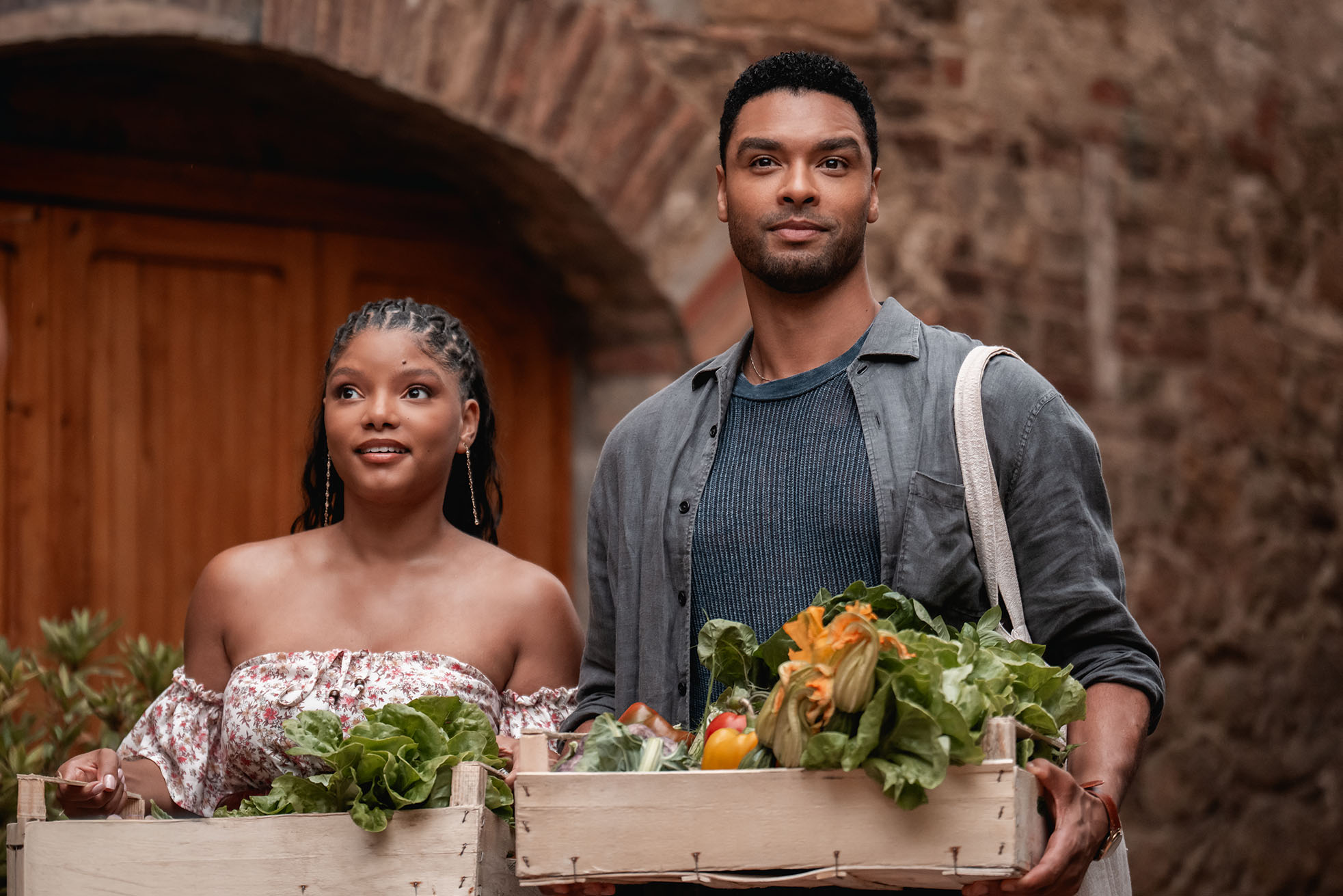 a scene from 'You, Me & Tuscany' movie with Halle Bailey and Regé-Jean Page